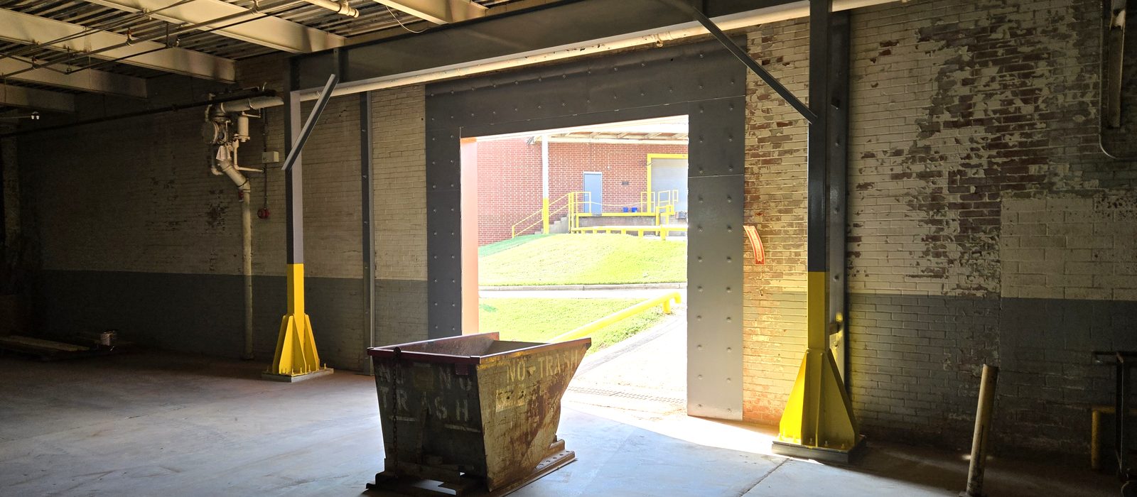 New structural steel columns and header beam framing an opening cut into an existing Charlotte building